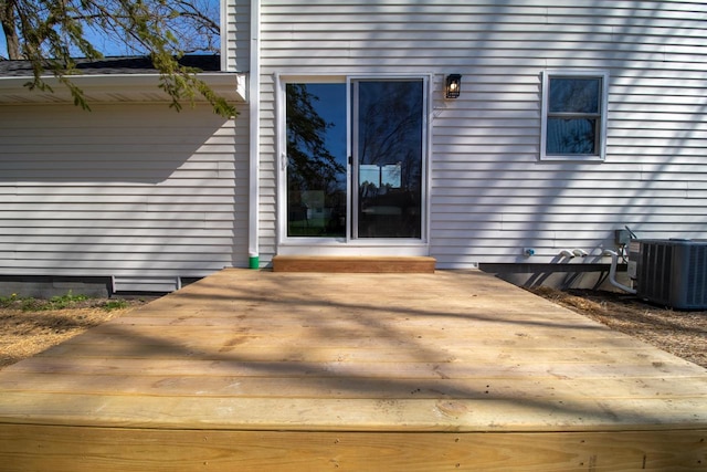entrance to property with a wooden deck and central air condition unit