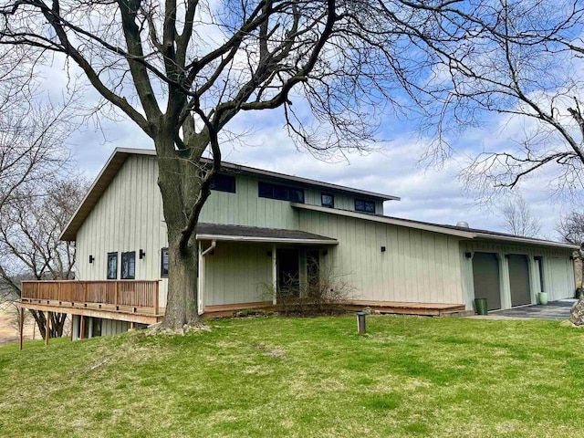 8226 Scott Rd, Cross Plains, WI 53528 - back of property featuring a lawn, an attached garage, a wooden deck, and driveway