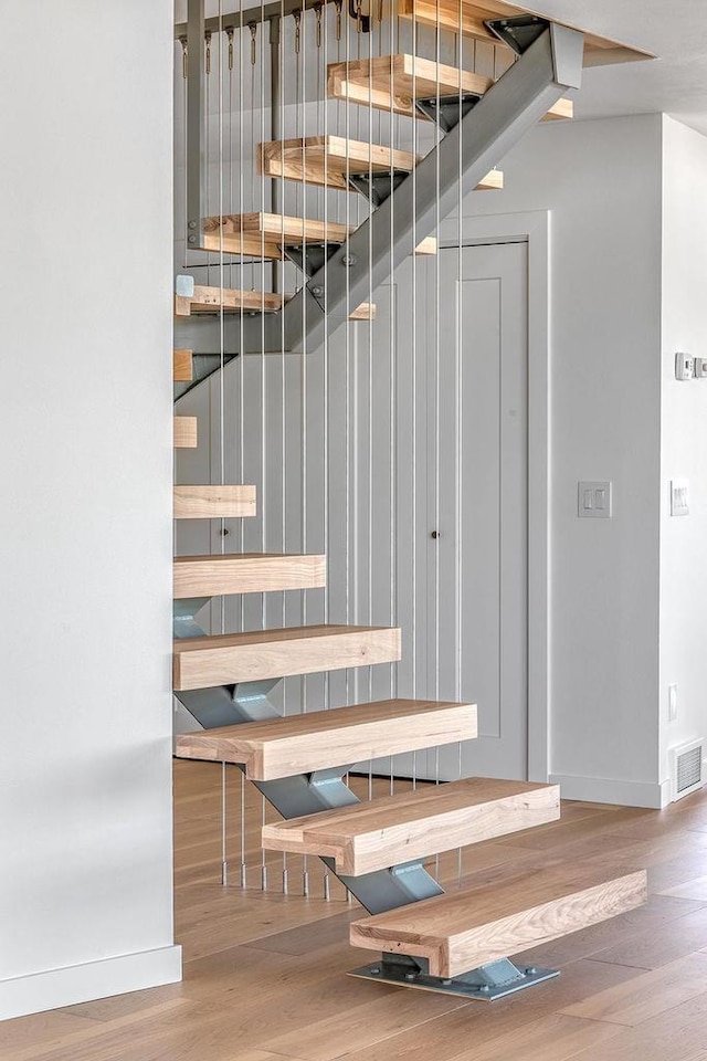 8226 Scott Rd, Cross Plains, WI 53528 - stairs featuring visible vents, baseboards, and wood finished floors