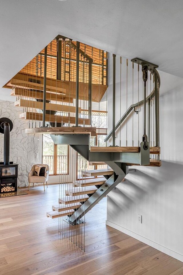 8226 Scott Rd, Cross Plains, WI 53528 - stairs with hardwood / wood-style flooring and a wood stove