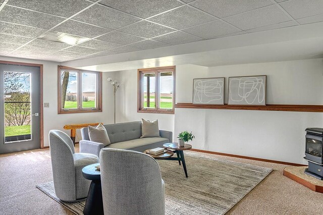 8226 Scott Rd, Cross Plains, WI 53528 - living room with a wood stove, carpet, and a paneled ceiling