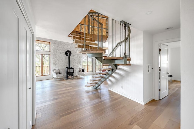 8226 Scott Rd, Cross Plains, WI 53528 - staircase featuring a wood stove, a wealth of natural light, and hardwood / wood-style floors