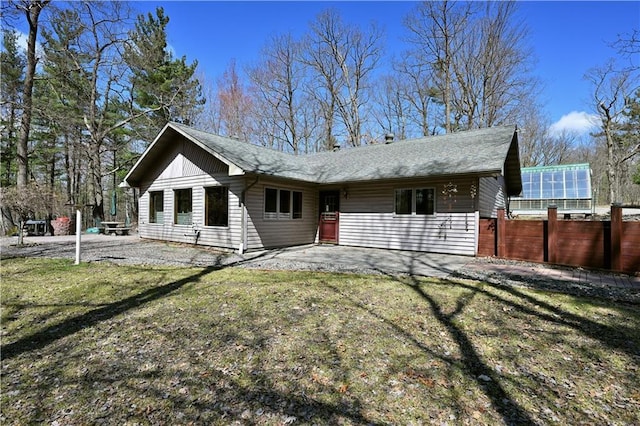 W3803 Church Rd, Sarona, WI 54870 - rear view of property with fence, a yard, a patio, and a shingled roof