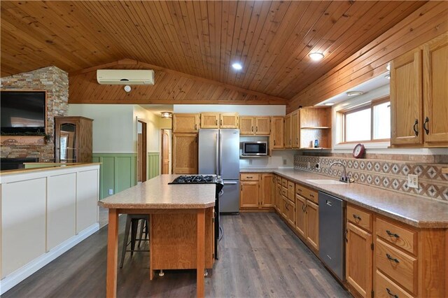 W3803 Church Rd, Sarona, WI 54870 - kitchen featuring an AC wall unit, lofted ceiling, a center island, and stainless steel appliances