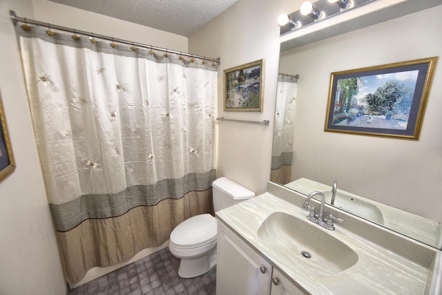 full bath with a shower with curtain, vanity, a textured ceiling, and toilet