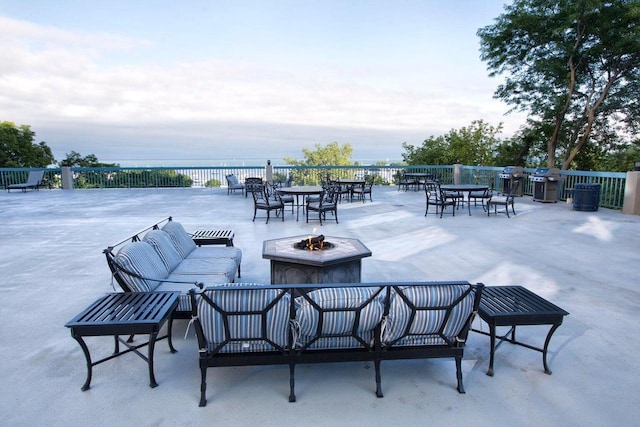 view of patio featuring a fire pit and a water view