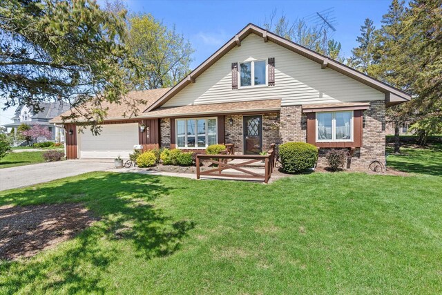 618 W Main St, Waterford, WI 53185 - view of front of house featuring asphalt driveway, a garage, a front lawn, and brick siding