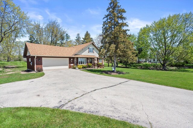 618 W Main St, Waterford, WI 53185 - view of front of property with a garage, asphalt driveway, and a front lawn