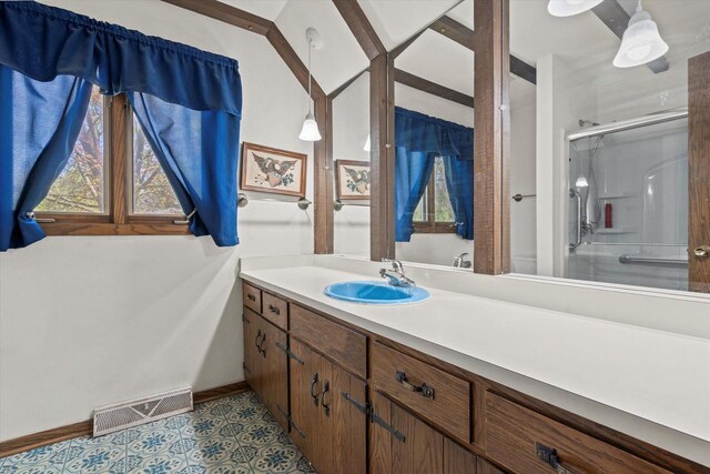 618 W Main St, Waterford, WI 53185 - full bathroom with a stall shower, vanity, and baseboards