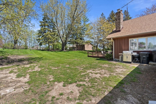 618 W Main St, Waterford, WI 53185 - view of green lawn featuring a wooden deck