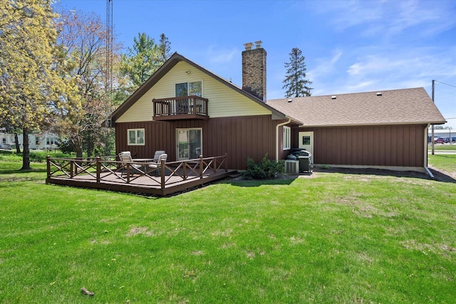618 W Main St, Waterford, WI 53185 - back of house with a balcony, a chimney, a lawn, and a deck