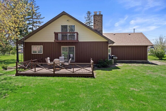 618 W Main St, Waterford, WI 53185 - back of house with a balcony, a chimney, a lawn, and a deck