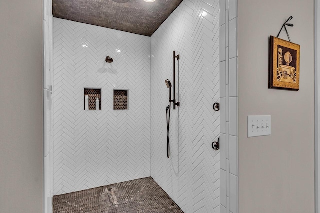 full bathroom featuring tiled shower