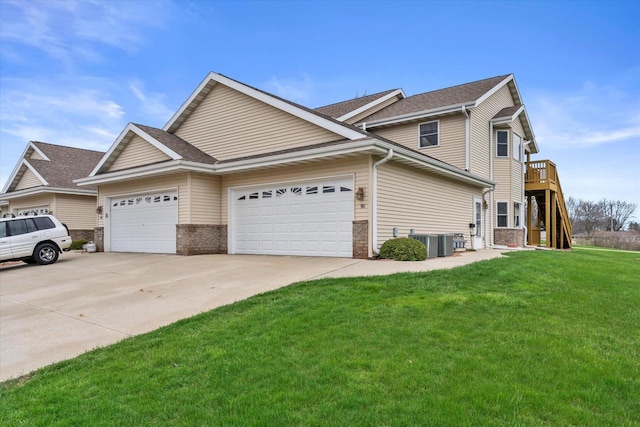 view of front facade with brick siding, central AC, a front lawn, concrete driveway, and an attached garage