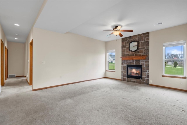 unfurnished living room with carpet flooring, a ceiling fan, visible vents, and baseboards
