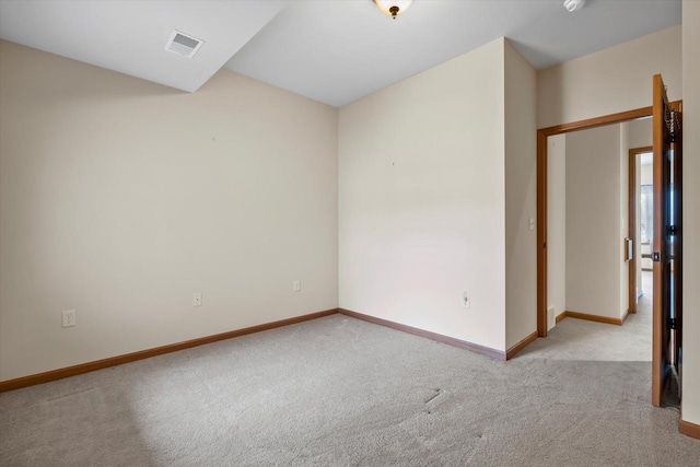 empty room with visible vents, carpet flooring, and baseboards