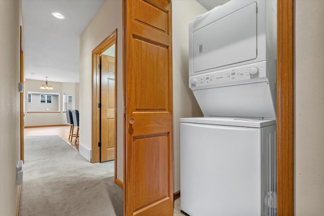 laundry area with recessed lighting, stacked washer and dryer, laundry area, a chandelier, and carpet flooring