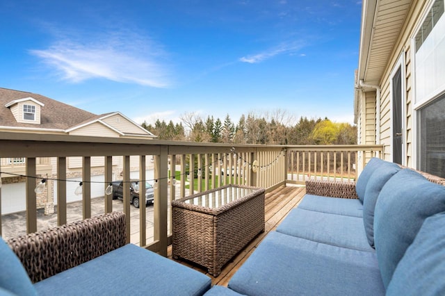 wooden terrace with an outdoor living space