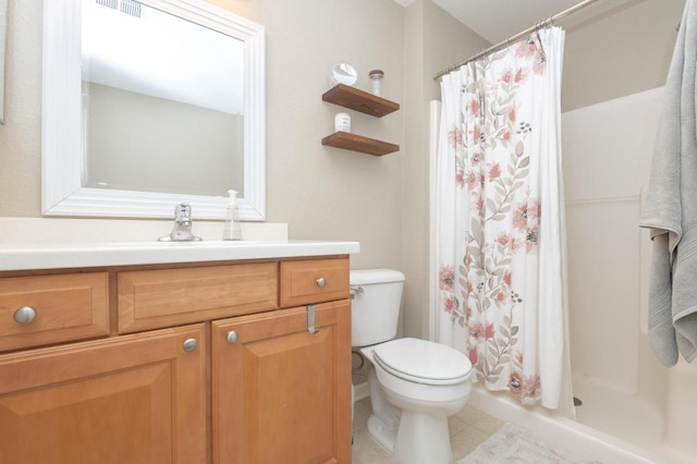 full bath featuring tile patterned floors, vanity, toilet, and a stall shower