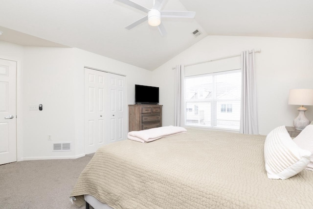 carpeted bedroom featuring a closet, visible vents, ceiling fan, and lofted ceiling