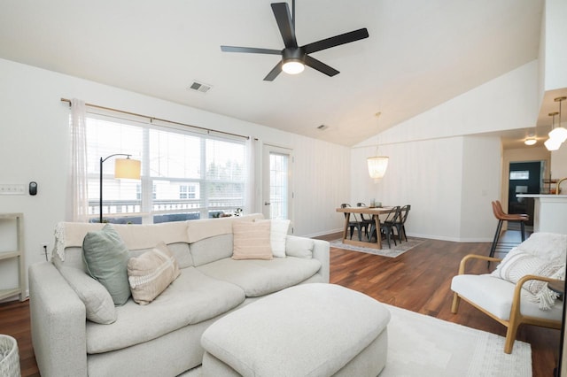 living room with a ceiling fan, visible vents, wood finished floors, and baseboards