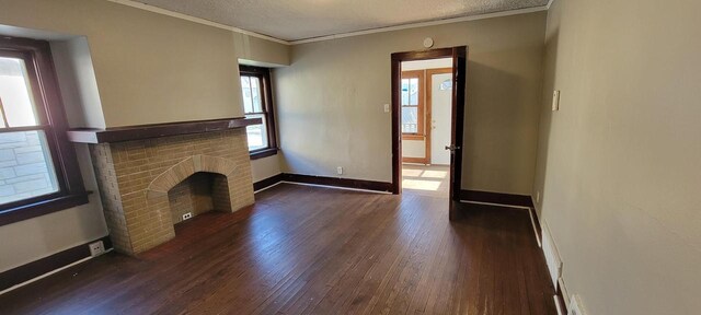 4226 W Sieben Pl, Milwaukee, WI 53216 - unfurnished living room with ornamental molding, dark wood-style flooring, a brick fireplace, baseboards, and a textured ceiling