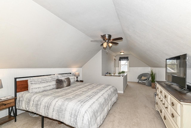 bedroom featuring ceiling fan, vaulted ceiling, and light carpet