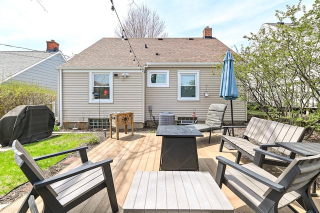 deck featuring central AC, grilling area, and an outdoor fire pit