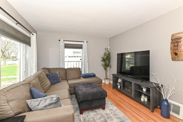 living area with visible vents and light wood-style flooring