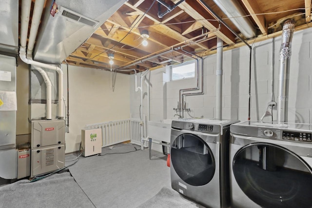 laundry room with visible vents, laundry area, and washing machine and dryer
