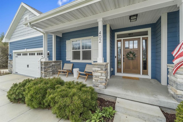 402 Burnt Sienna Dr, Middleton, WI 53562 - property entrance with covered porch, stone siding, driveway, and an attached garage