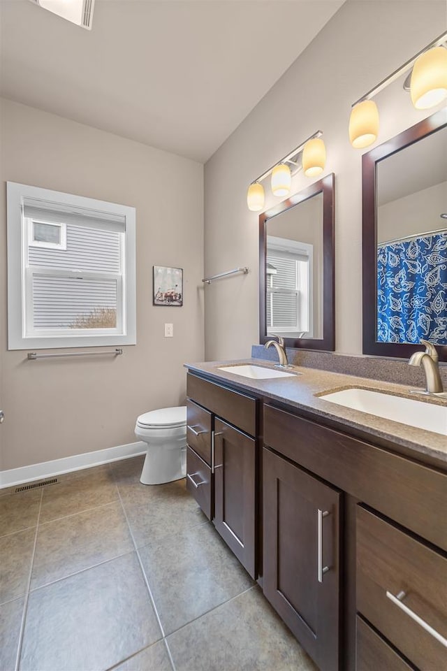402 Burnt Sienna Dr, Middleton, WI 53562 - bathroom featuring toilet, tile patterned flooring, double vanity, and a sink