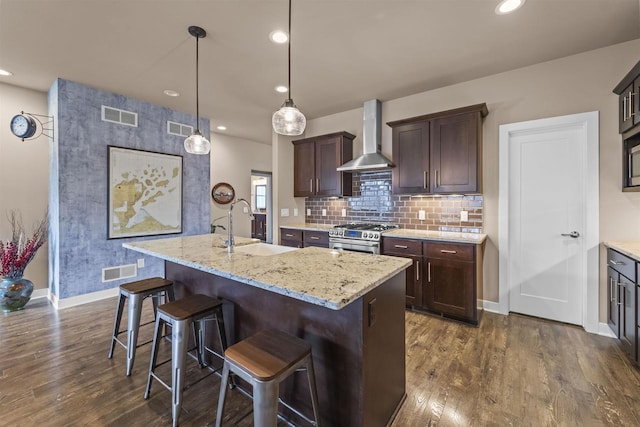 402 Burnt Sienna Dr, Middleton, WI 53562 - kitchen with stainless steel gas range oven, wall chimney exhaust hood, visible vents, and a sink