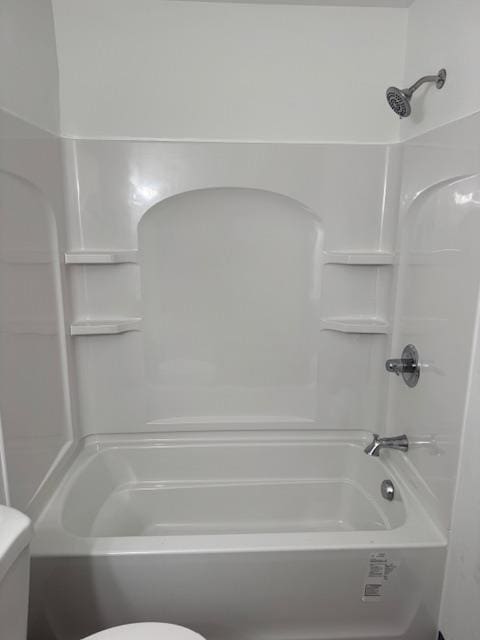 full bath with washtub / shower combination and toilet