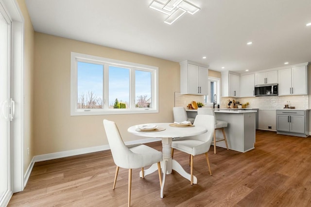 2352 Ryan Ave, Plymouth, WI 53073 - dining space featuring light wood finished floors, recessed lighting, baseboards, and a healthy amount of sunlight