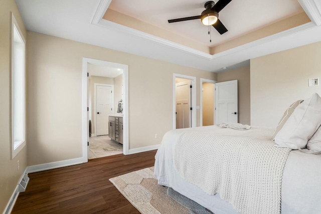 2352 Ryan Ave, Plymouth, WI 53073 - bedroom featuring connected bathroom, a raised ceiling, visible vents, baseboards, and wood finished floors