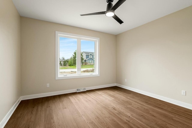 2352 Ryan Ave, Plymouth, WI 53073 - spare room featuring visible vents, ceiling fan, wood finished floors, and baseboards
