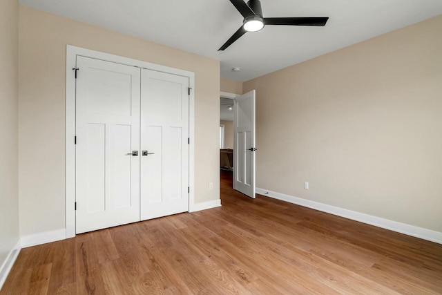 2352 Ryan Ave, Plymouth, WI 53073 - unfurnished bedroom featuring a closet, a ceiling fan, light wood-style flooring, and baseboards