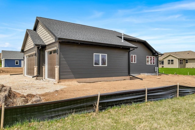 2352 Ryan Ave, Plymouth, WI 53073 - view of home's exterior featuring roof with shingles, an attached garage, and fence