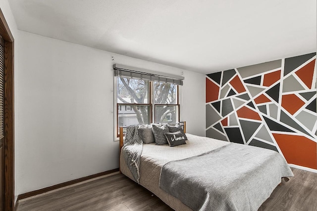 bedroom featuring baseboards and wood finished floors