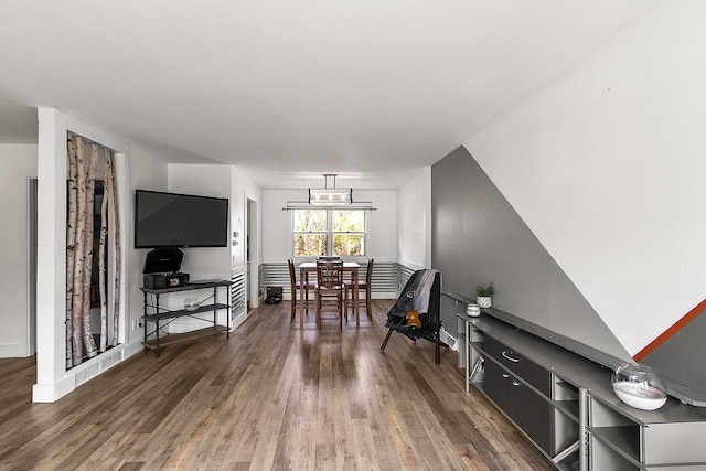 living area with baseboards and wood finished floors