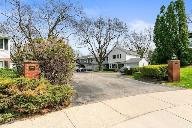 view of front of house with a residential view and uncovered parking