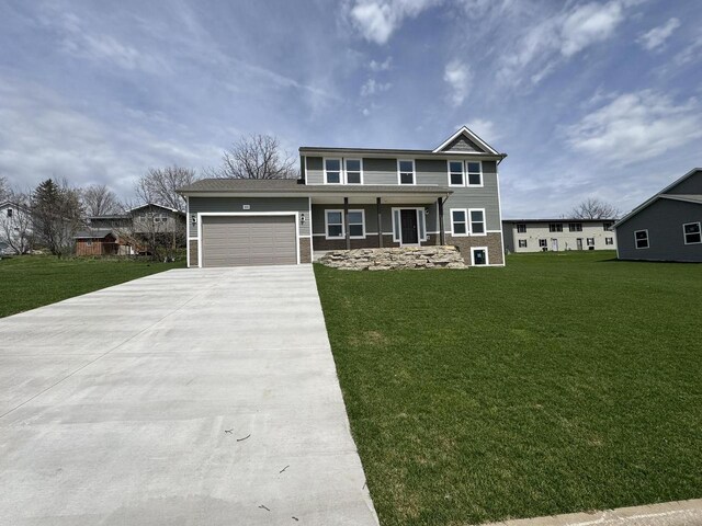 306 Filardo Ct, Mineral Point, WI 53565 - view of front facade with concrete driveway, a front yard, and a garage