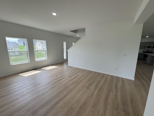 306 Filardo Ct, Mineral Point, WI 53565 - unfurnished living room with recessed lighting, wood finished floors, and baseboards