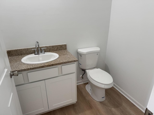 306 Filardo Ct, Mineral Point, WI 53565 - bathroom with toilet, vanity, wood finished floors, and baseboards