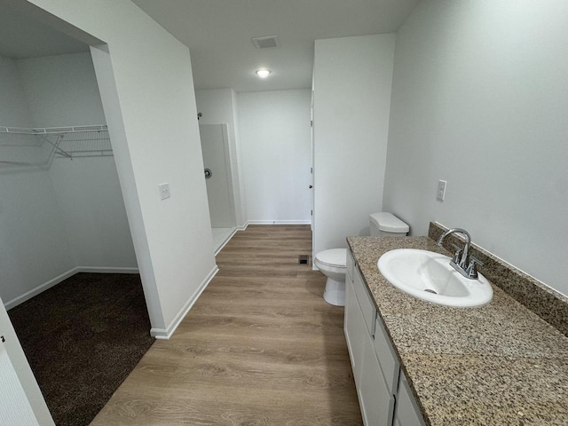 306 Filardo Ct, Mineral Point, WI 53565 - full bath featuring a spacious closet, visible vents, toilet, wood finished floors, and vanity