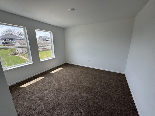 306 Filardo Ct, Mineral Point, WI 53565 - unfurnished room featuring dark colored carpet and baseboards
