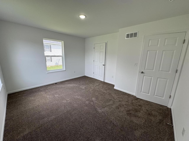 306 Filardo Ct, Mineral Point, WI 53565 - unfurnished bedroom with baseboards, visible vents, dark colored carpet, and recessed lighting
