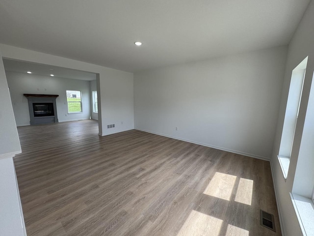 306 Filardo Ct, Mineral Point, WI 53565 - unfurnished living room featuring visible vents, wood finished floors, recessed lighting, and a glass covered fireplace