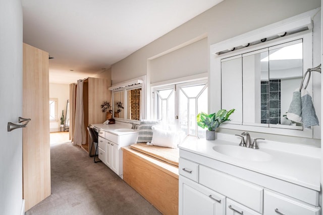 bathroom with two vanities and a sink